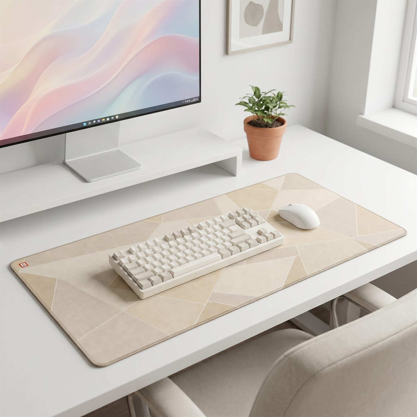 A cream keyboard and matching mouse sitting on a BACKSTOCK desk mat